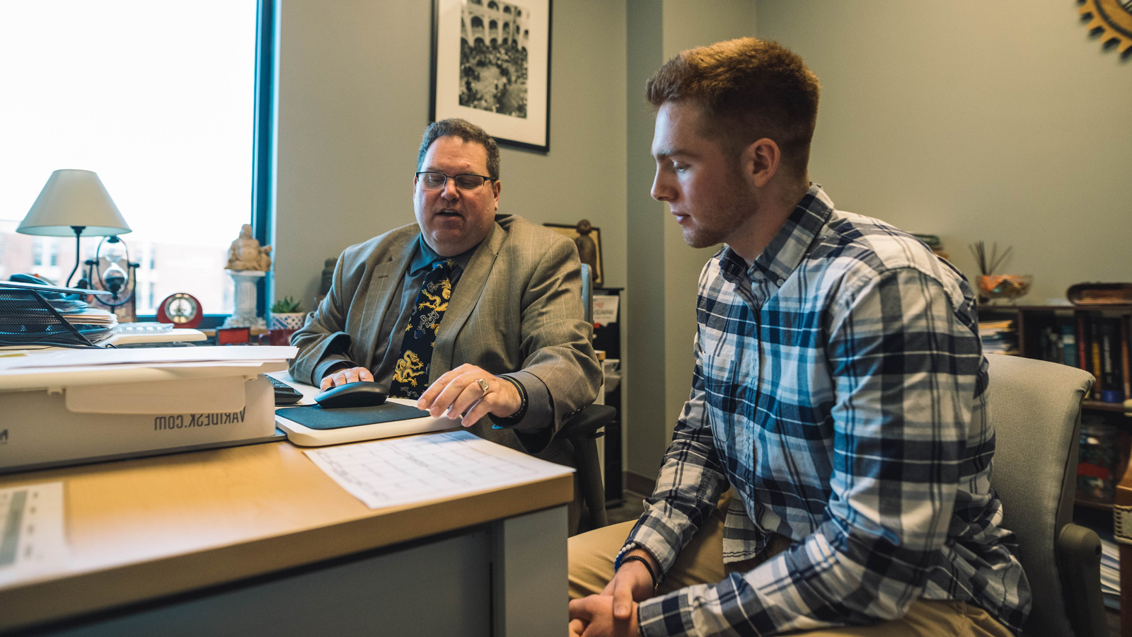 business administration professor meets with student